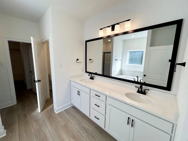 a bathroom with a double vanity sink and mirror