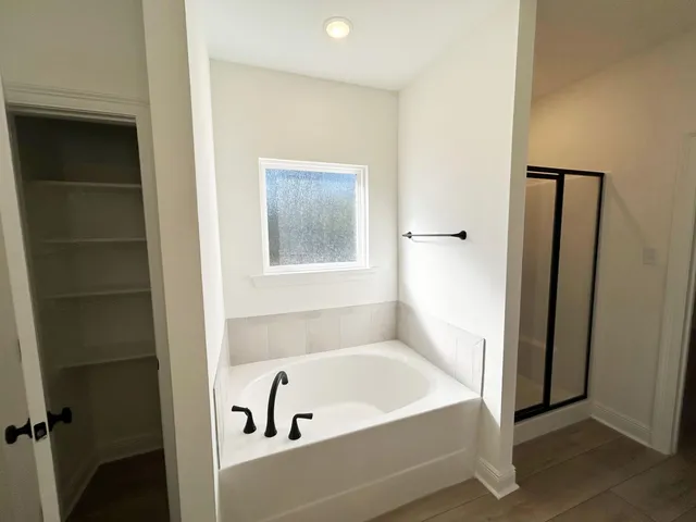 a bathroom with a tub and shower