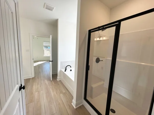 view of a bathroom with a glass door shower