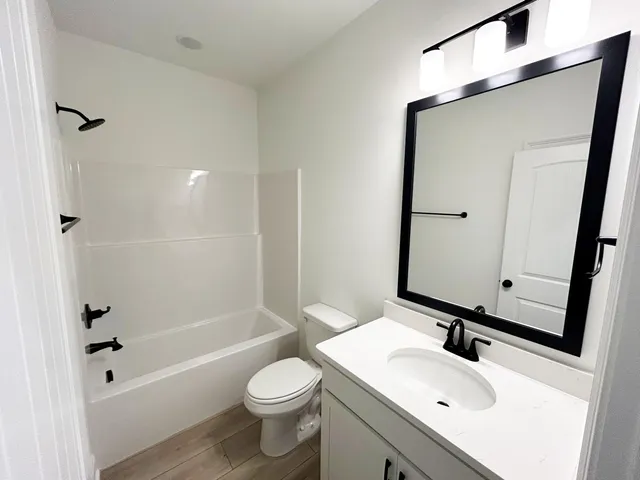 a view of a room with wooden floor