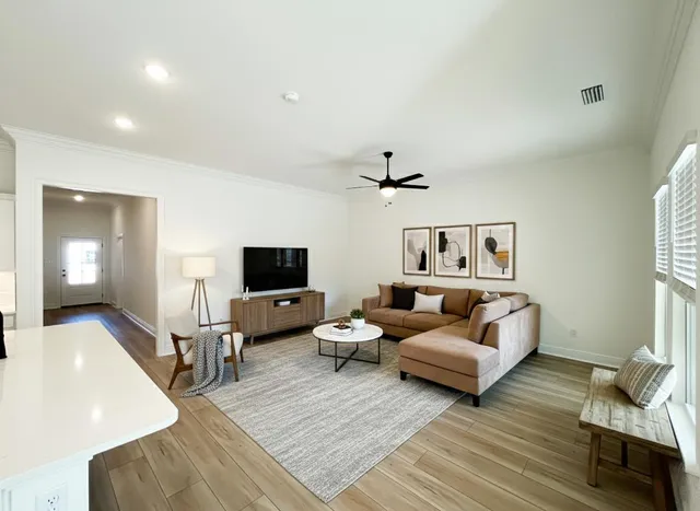 a living room with furniture and a flat screen tv