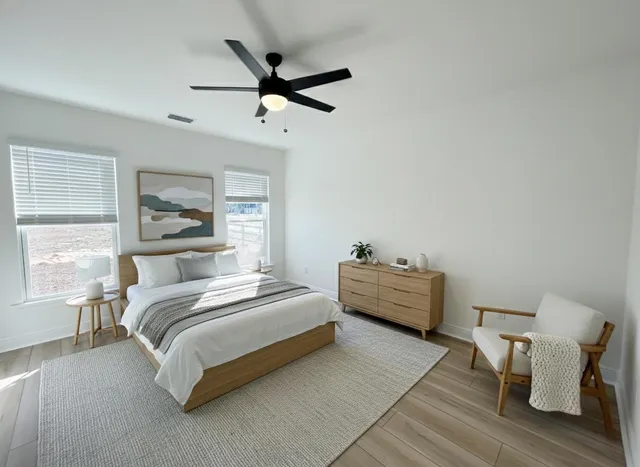 a spacious bedroom with a bed and a window