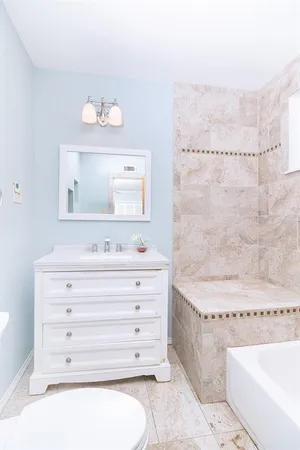 a bathroom with a bathtub a sink and a mirror