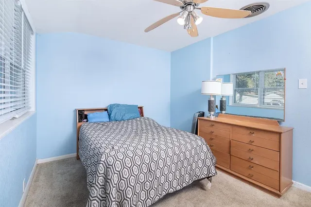 a bedroom with a bed and a dresser