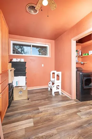 a view of a livingroom with wooden floor and a fireplace