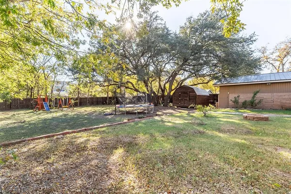 a view of yard with swimming pool and green space