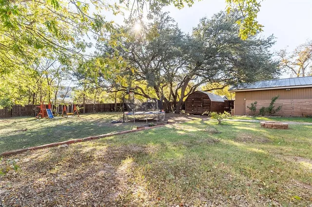 a view of yard with swimming pool and green space