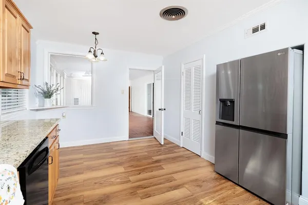 a kitchen with granite countertop a refrigerator and a sink