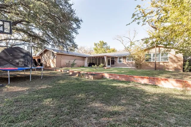 a view of a house with backyard and sitting area