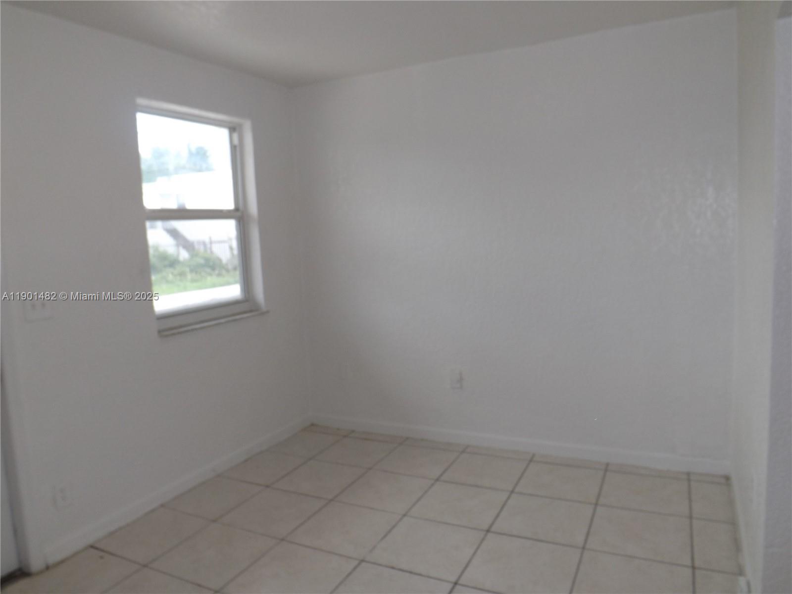 160 Northwest 11th Terrace, Unit 2 Miami, FL 33136 - Photo 8 of 9 an empty room with a window