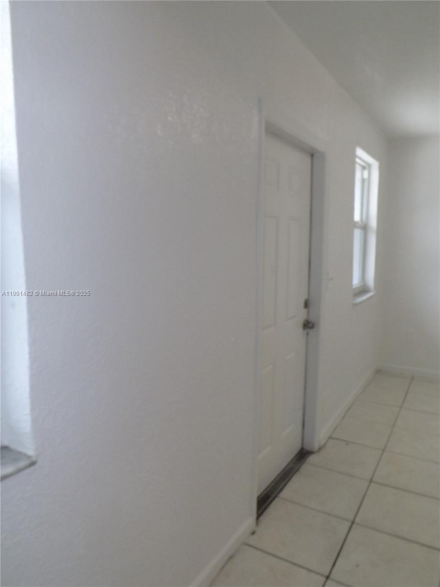 160 Northwest 11th Terrace, Unit 2 Miami, FL 33136 - Photo 9 of 9 a view of an empty room with windows