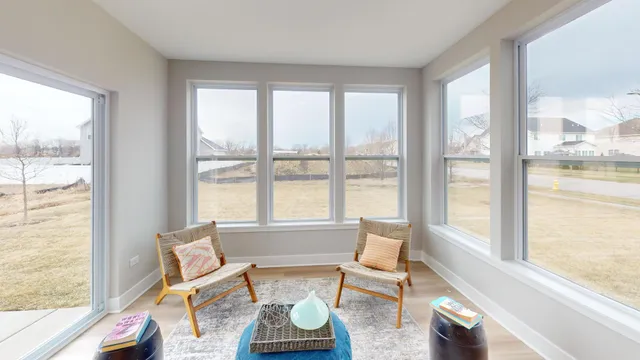 a living room with furniture and floor to ceiling windows