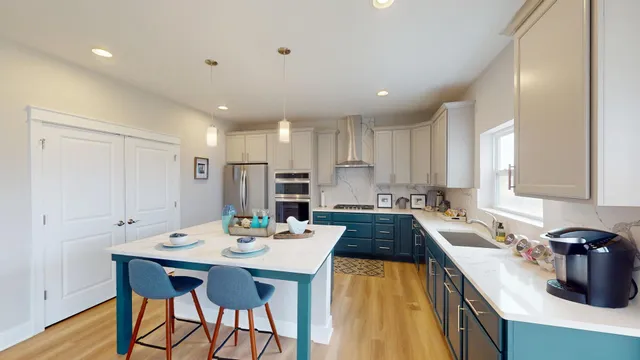 a kitchen with stainless steel appliances granite countertop a sink stove and cabinets