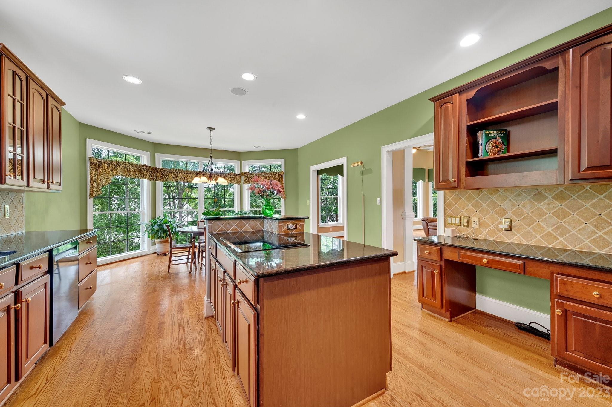 256 Hemingway Lane Fort Mill, SC 29708 - Photo 12 of 41 a kitchen with stainless steel appliances granite countertop a stove and a wooden floors