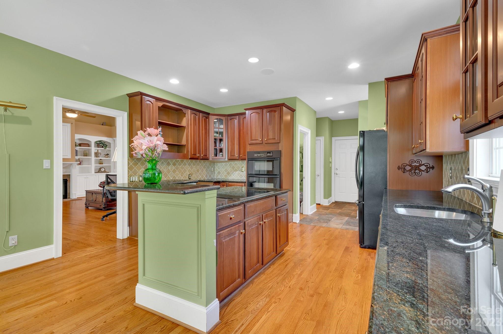 256 Hemingway Lane Fort Mill, SC 29708 - Photo 13 of 41 a kitchen with stainless steel appliances granite countertop a refrigerator a stove and a wooden floors