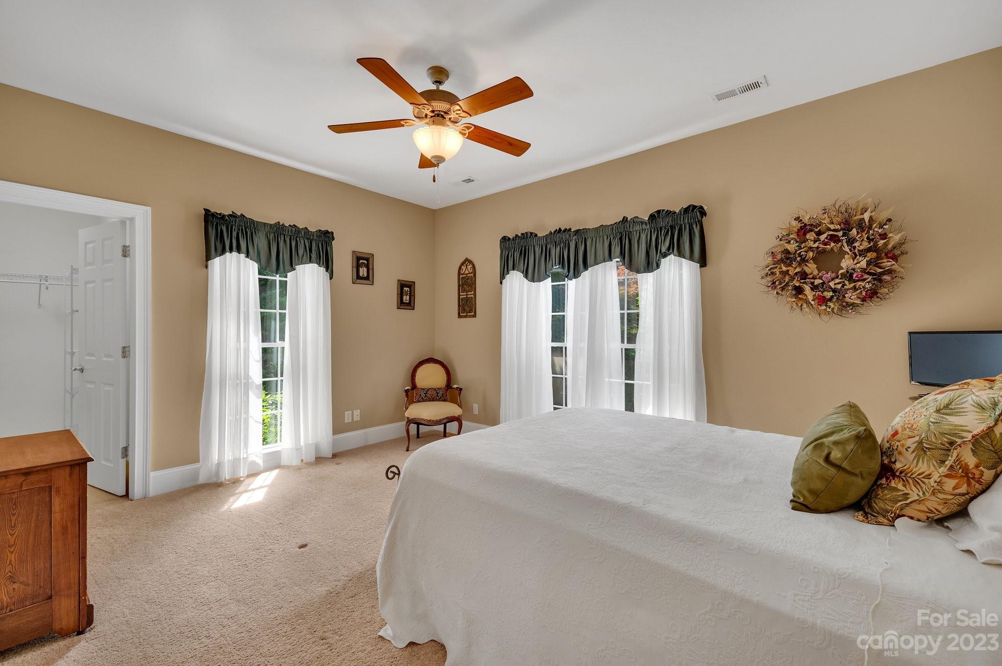 256 Hemingway Lane Fort Mill, SC 29708 - Photo 24 of 41 a bedroom with a bed next to a window and a chandelier