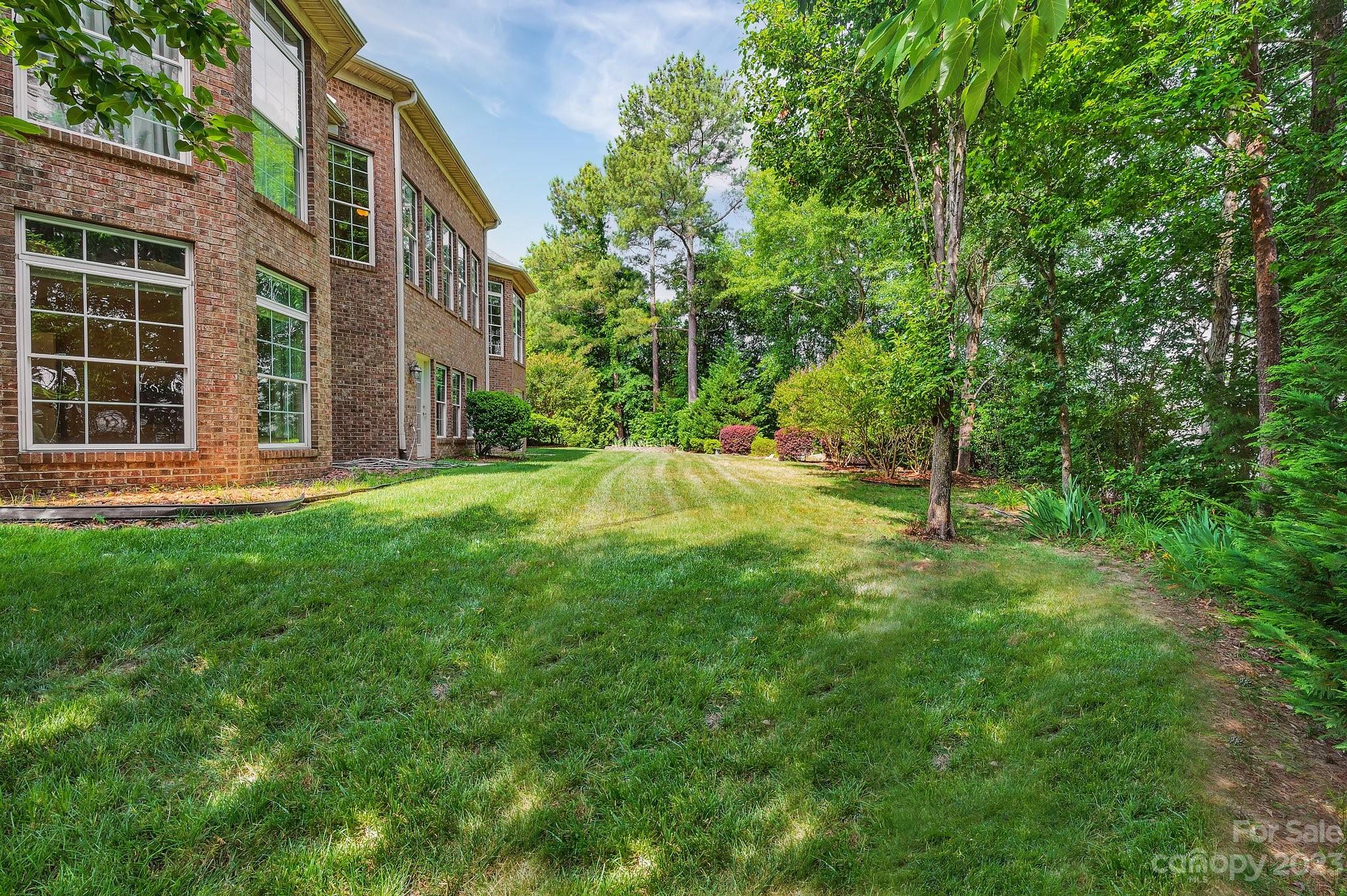 256 Hemingway Lane Fort Mill, SC 29708 - Photo 40 of 41 a backyard of a house with a garden and outdoor seating