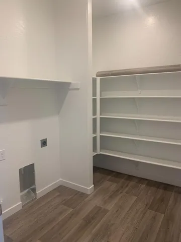 a view of walk in closet with empty racks
