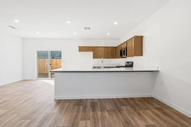 a view of kitchen with wooden floor