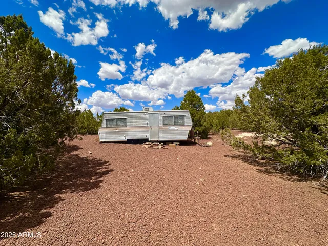 a front view of a house with a yard and garden