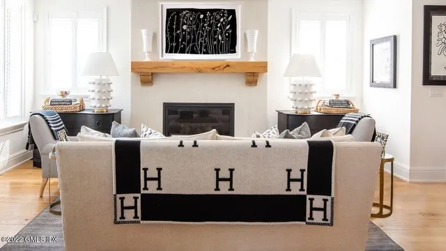 a living room with furniture a fireplace and a window