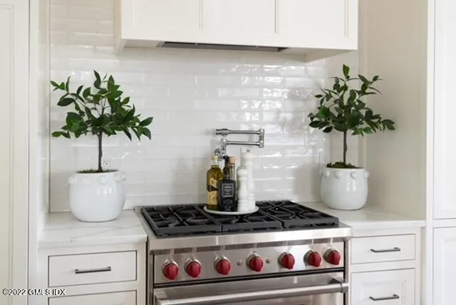 a white stove top oven sitting inside of a kitchen
