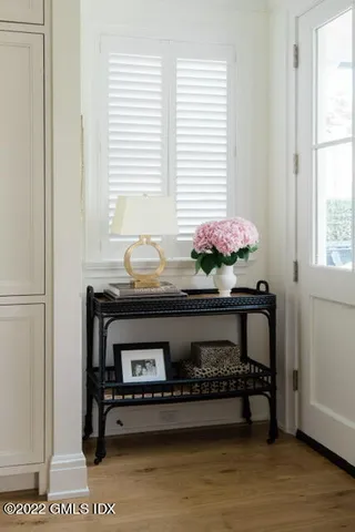 a room with a table chair and a window