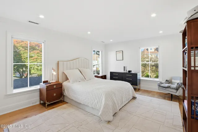 a bedroom with a bed and large window