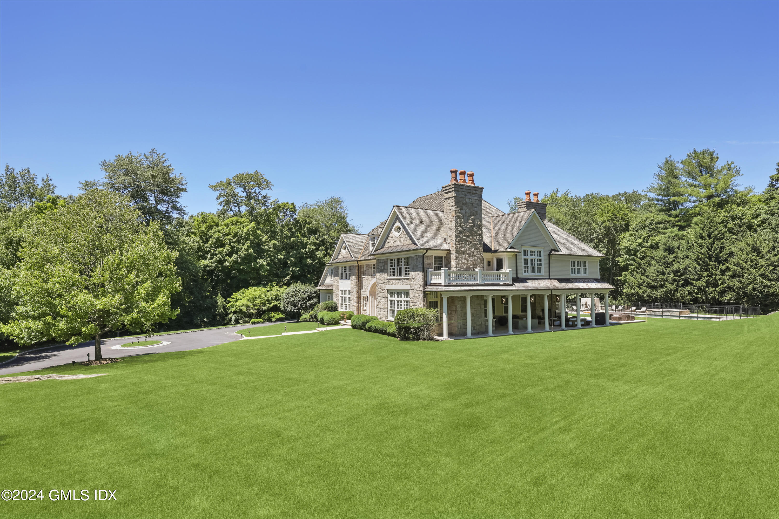 28 Thunder Mountain Road Greenwich, CT 06831 - Photo 32 of 32 a view of a house with a big yard and large trees