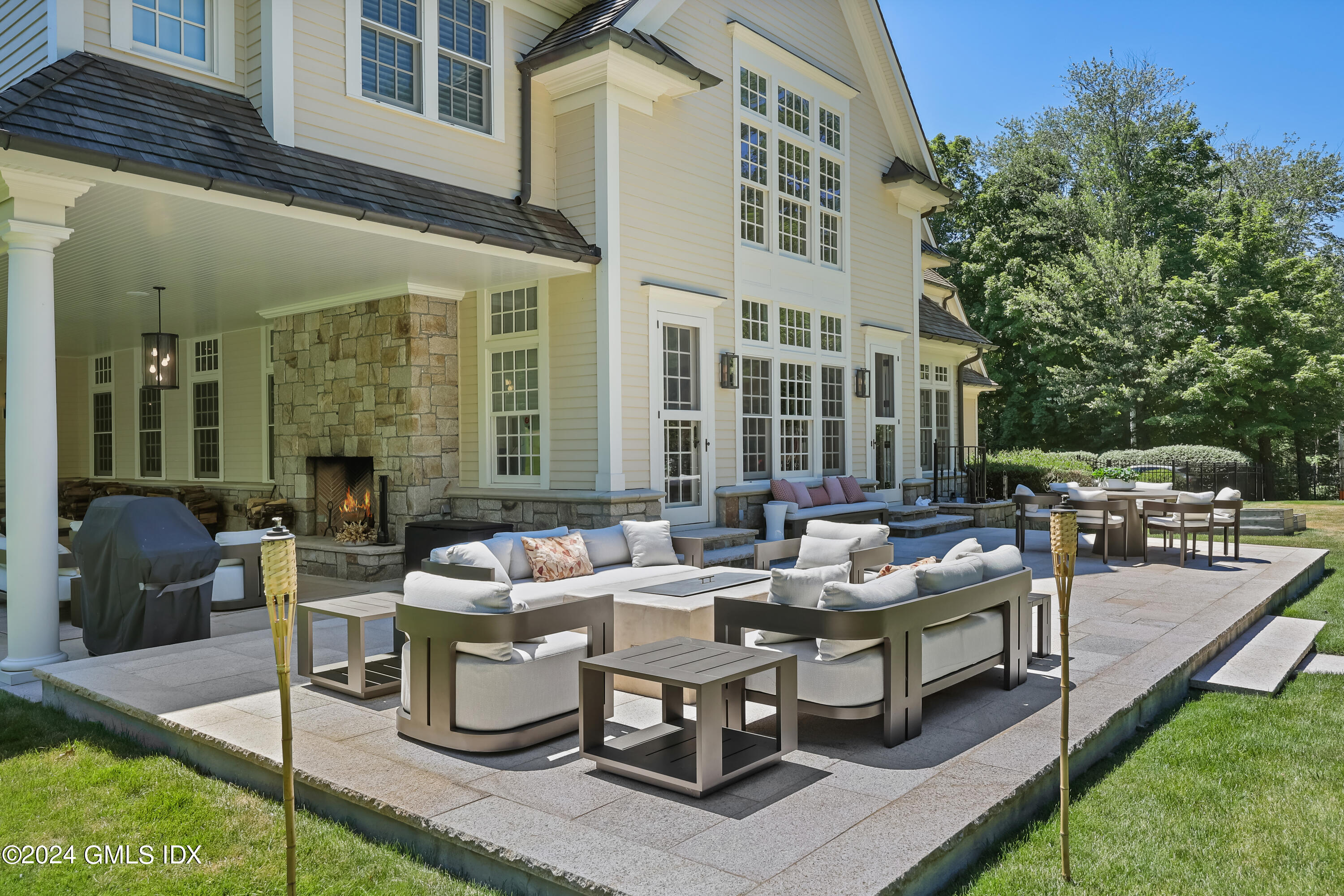 28 Thunder Mountain Road Greenwich, CT 06831 - Photo 5 of 32 a view of a patio with couches table and chairs and potted plants