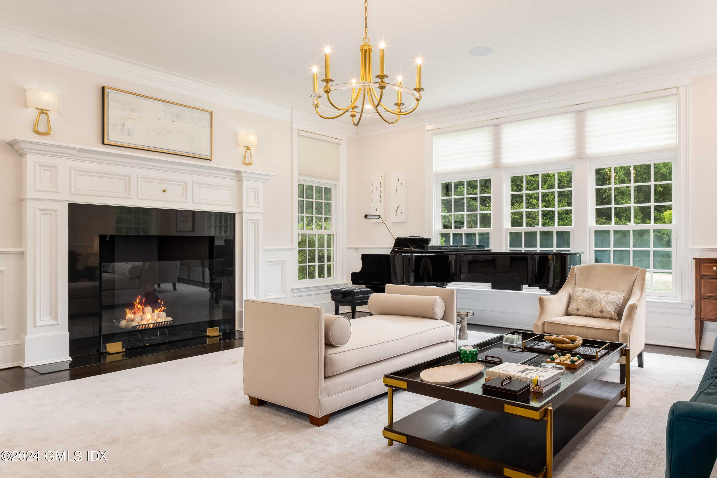 28 Thunder Mountain Road Greenwich, CT 06831 - Photo 7 of 32 a living room with furniture a fireplace and a chandelier