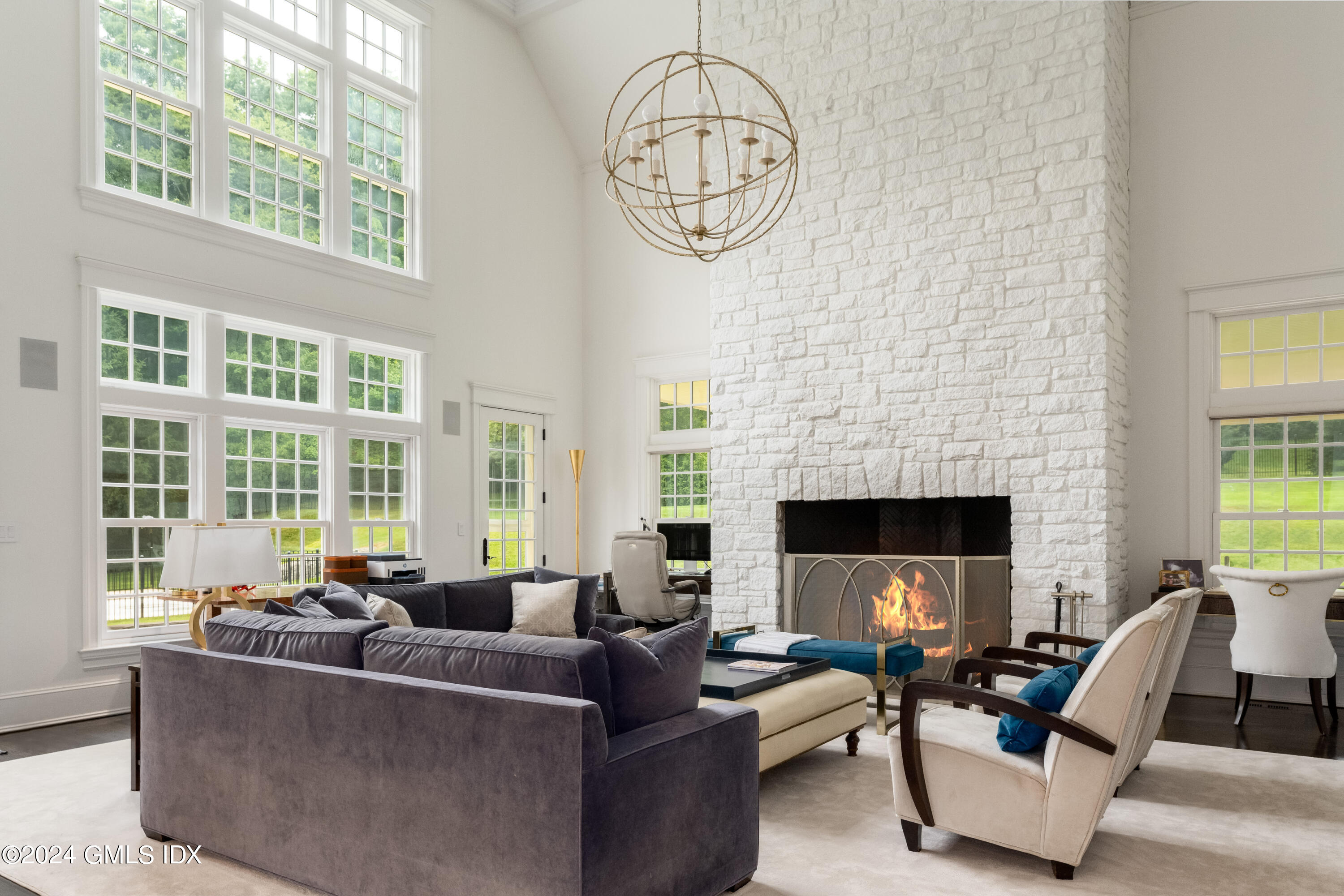28 Thunder Mountain Road Greenwich, CT 06831 - Photo 10 of 32 a living room with furniture a fireplace and a large window
