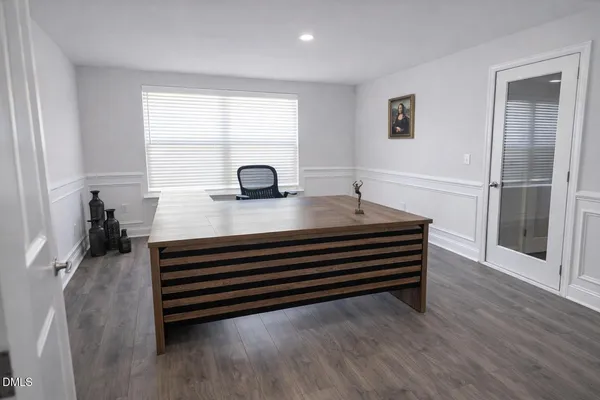 a view of a patio with table and chairs with wooden floor and fence