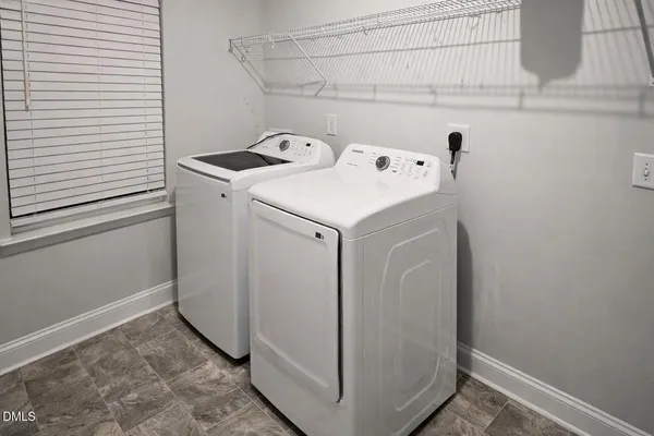 a spacious bedroom with a bed and a window