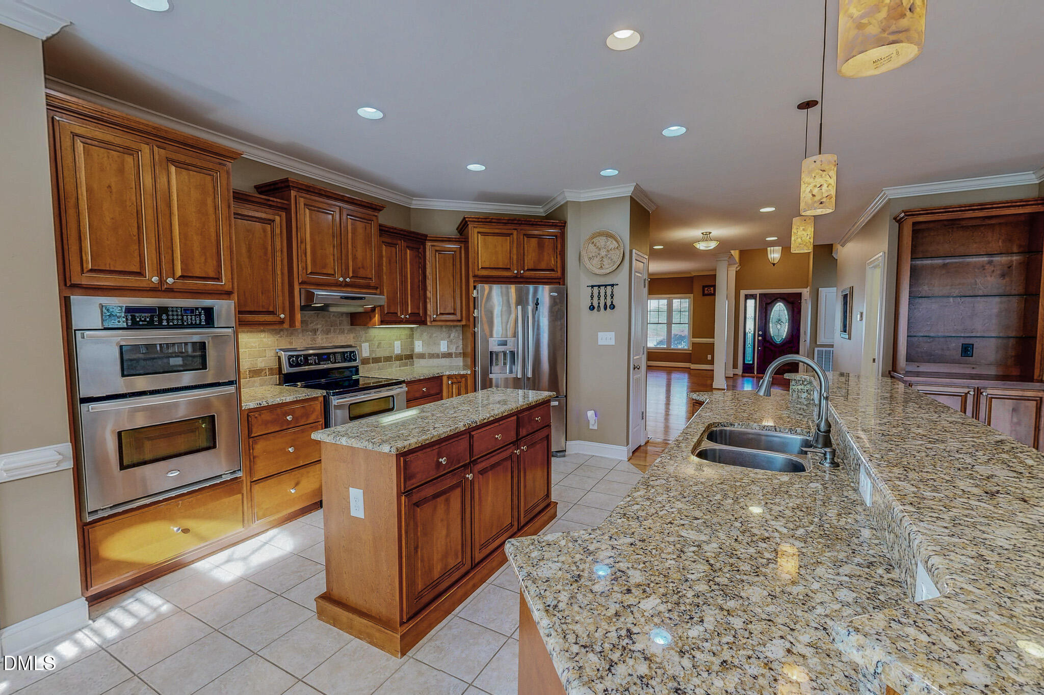 84 MacBeth Lane Roxboro, NC 27574 - Photo 14 of 64 a kitchen with kitchen island granite countertop a stove top oven a sink a counter top space and cabinets