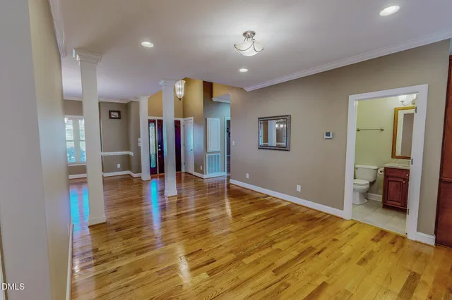 wooden floor in an empty room with a window