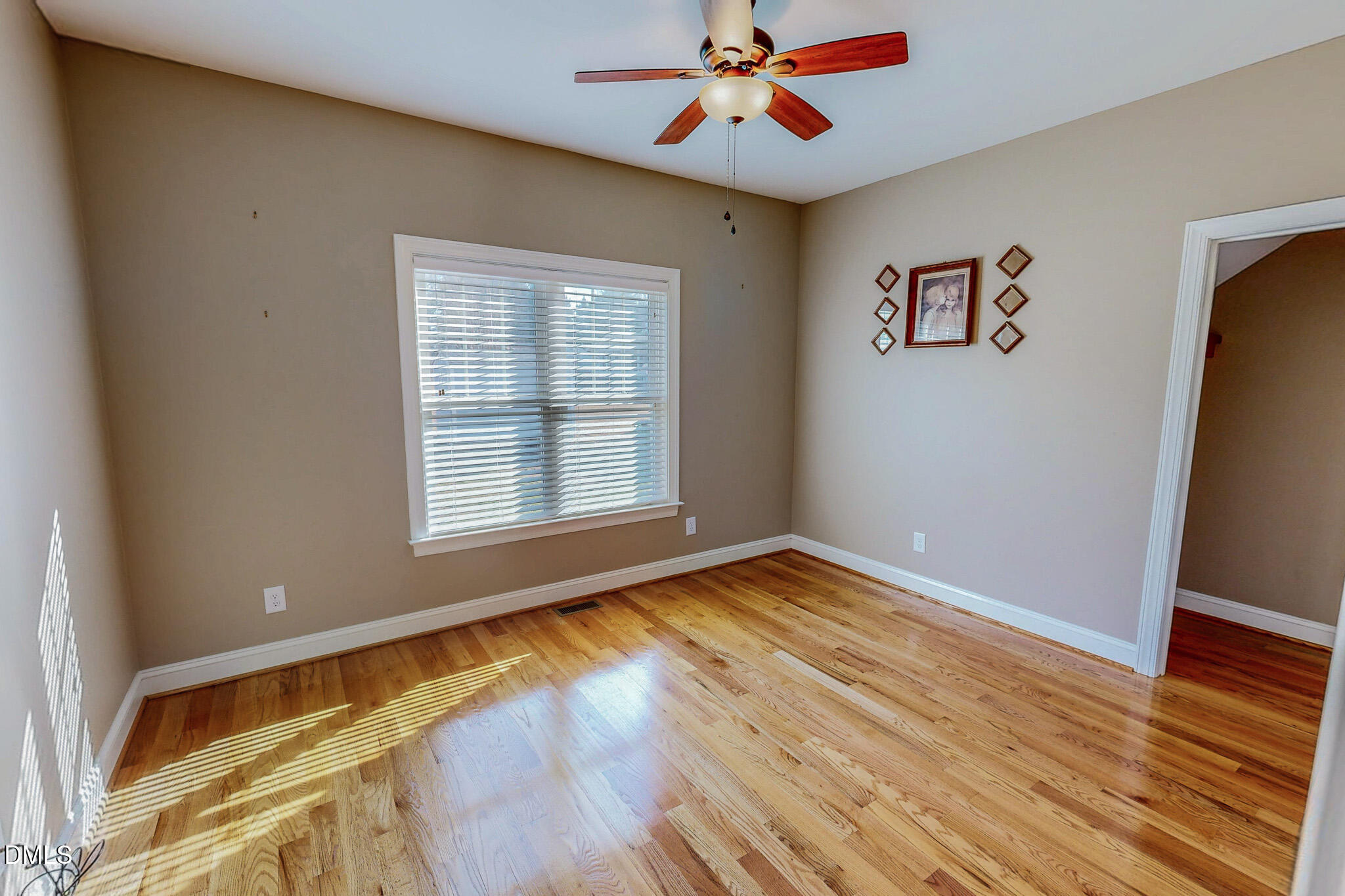 84 MacBeth Lane Roxboro, NC 27574 - Photo 50 of 64 a view of an empty room with wooden floor and a window