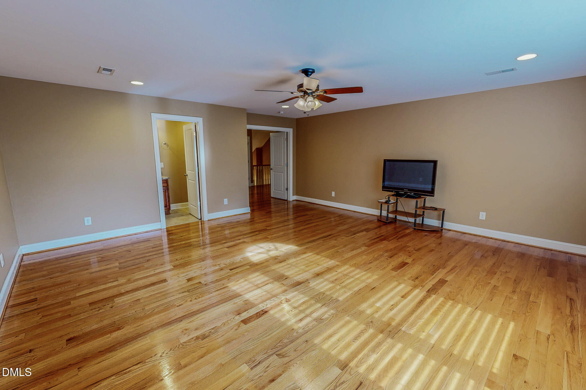 84 MacBeth Lane Roxboro, NC 27574 - Photo 58 of 64 a view of an empty room with wooden floor and a ceiling fan