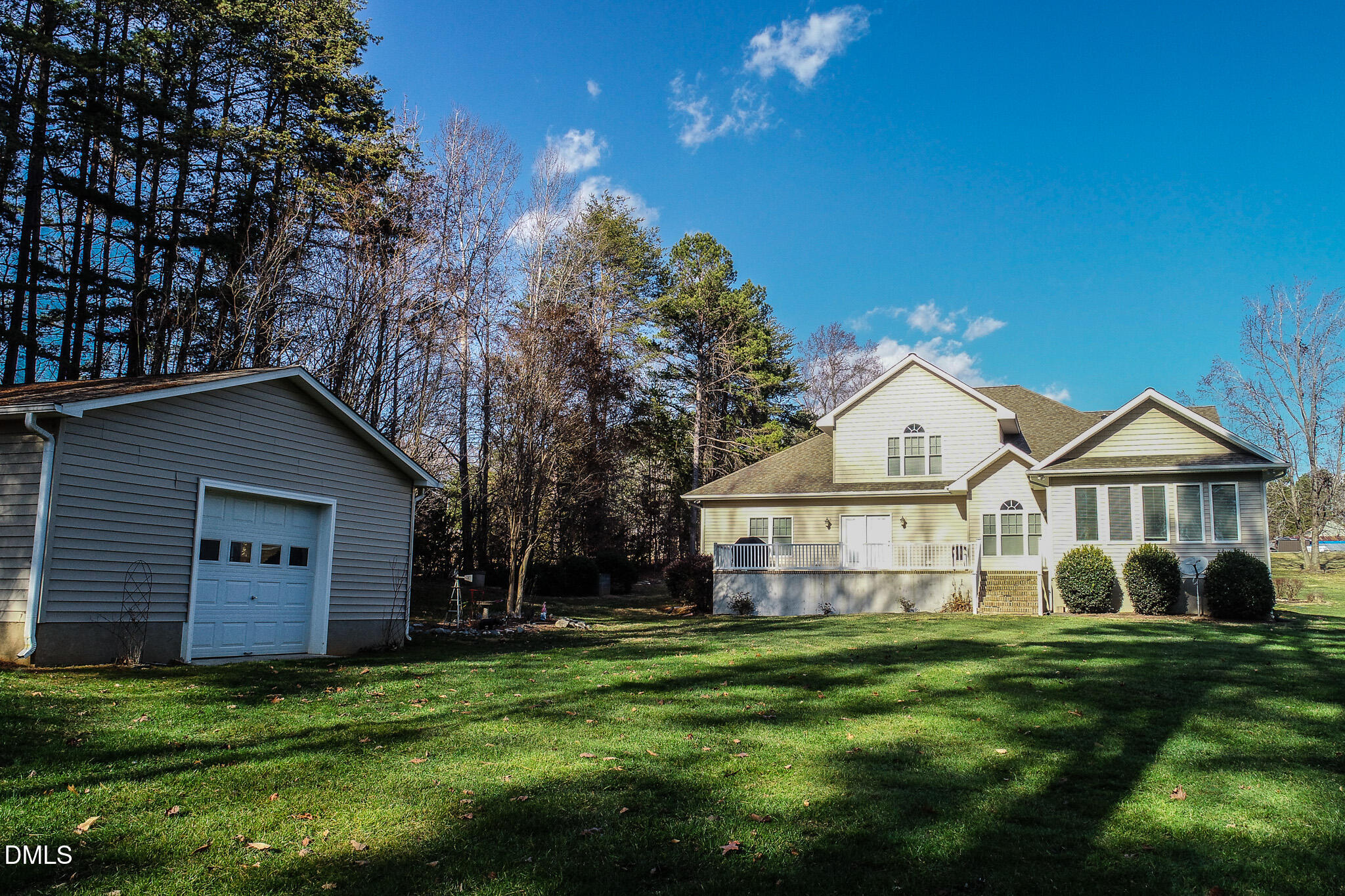 84 MacBeth Lane Roxboro, NC 27574 - Photo 6 of 64 a view of a yard in front of a house with plants and large tree