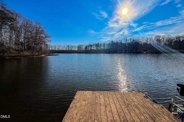 a kitchen with kitchen island granite countertop a stove top oven a sink a counter top space and cabinets