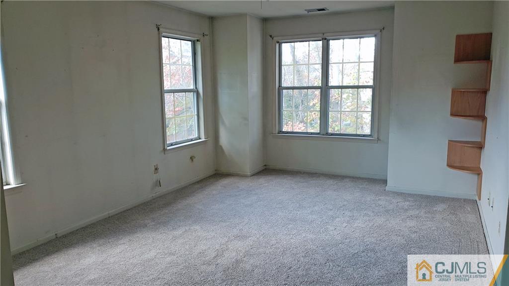710 Meadow Court, Unit 710 Helmetta, NJ 08828 - Photo 2 of 11 an empty room with windows
