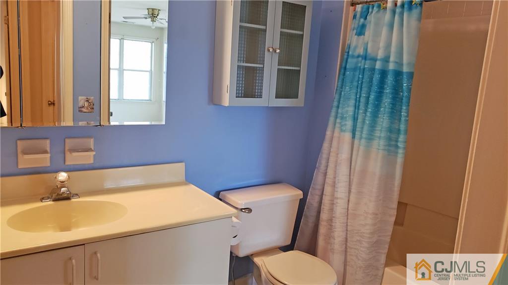 710 Meadow Court, Unit 710 Helmetta, NJ 08828 - Photo 4 of 11 a bathroom with a sink and a toilet