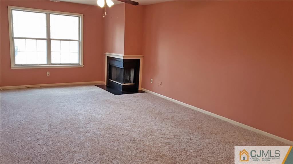 710 Meadow Court, Unit 710 Helmetta, NJ 08828 - Photo 6 of 11 an empty room with windows