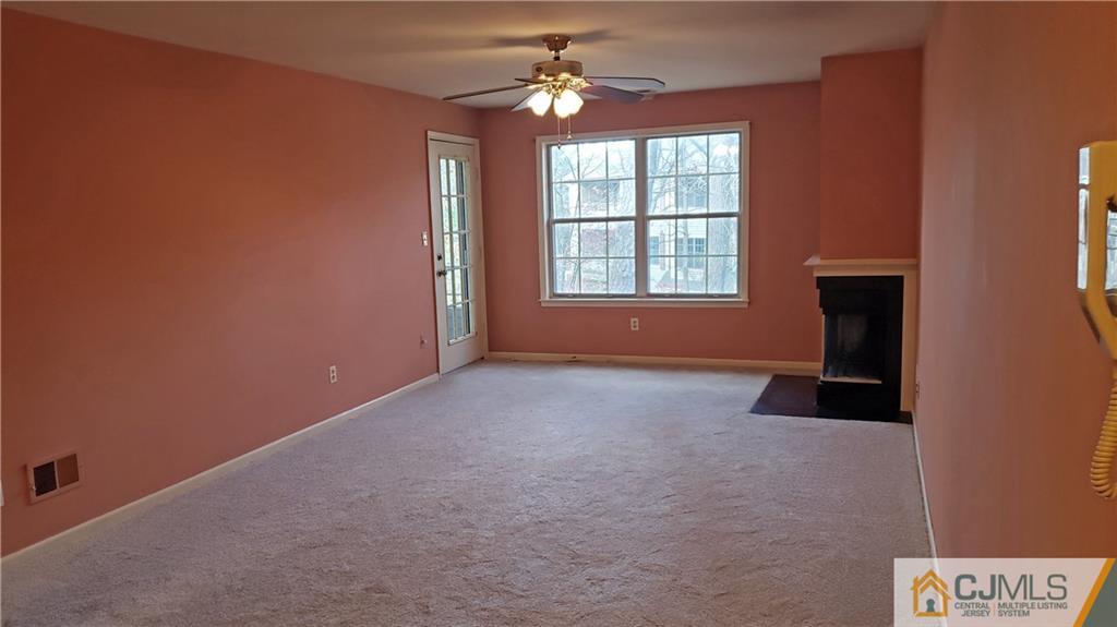 710 Meadow Court, Unit 710 Helmetta, NJ 08828 - Photo 7 of 11 an empty room with windows and fan