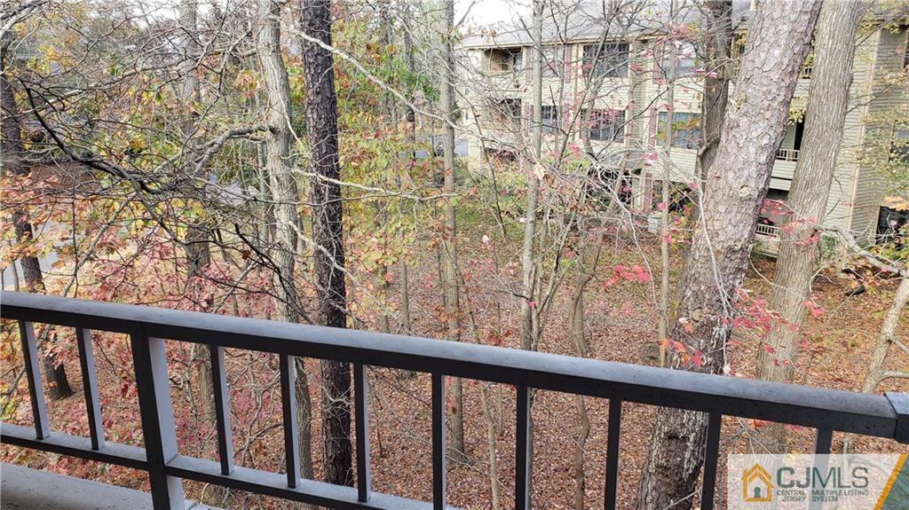 710 Meadow Court, Unit 710 Helmetta, NJ 08828 - Photo 9 of 11 a view of a balcony with a trees