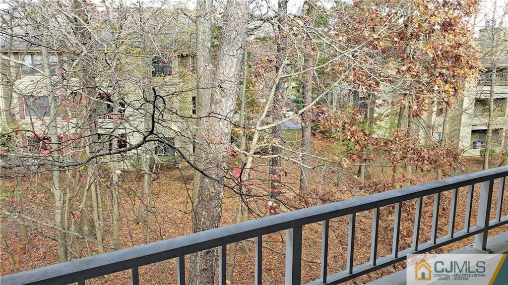 710 Meadow Court, Unit 710 Helmetta, NJ 08828 - Photo 10 of 11 a view of a balcony with wooden fence