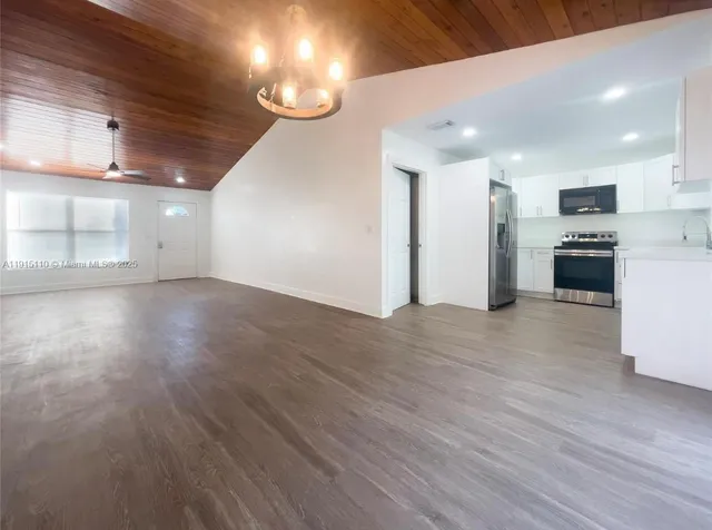 a view of a kitchen with a sink and a refrigerator