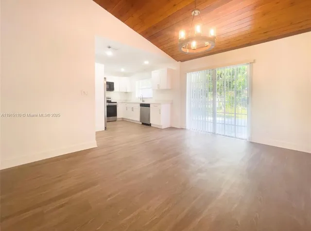 a view of a kitchen with a sink and a window