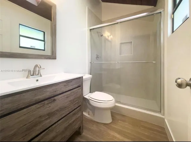 a bathroom with a white toilet sitting next to a bathroom sink