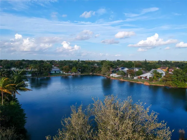 an aerial view of a houses with ocean view